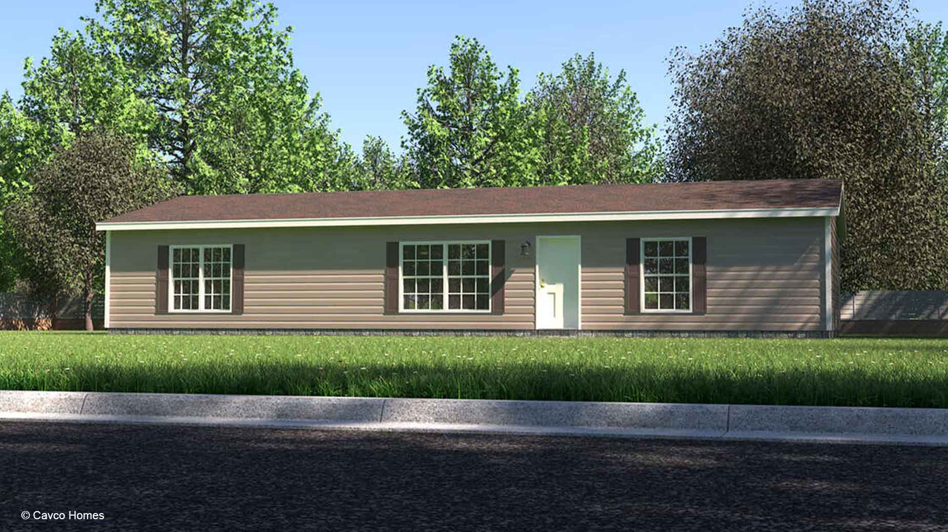 Single-story beige manufactured home with white trim, large windows, and a brown roof, surrounded by trees and grass.